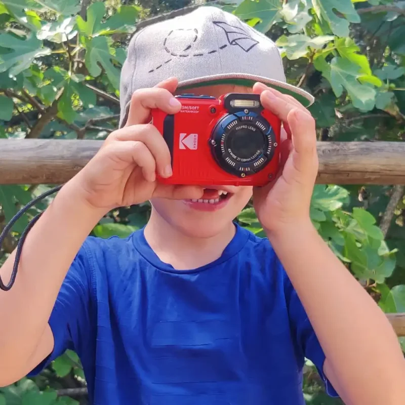 Family using Kodak PIXPRO WPZ2 to take selfie while snorkeling in clear blue ocean